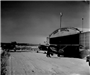 Vintage Photo of Airplane Parked Outside Service Hangar