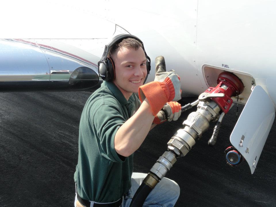 Man Putting Fuel in Airplane